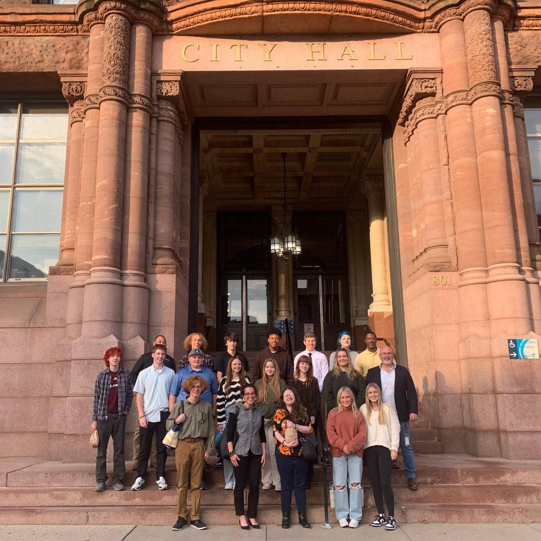 Students pose for a photo outside City Hall